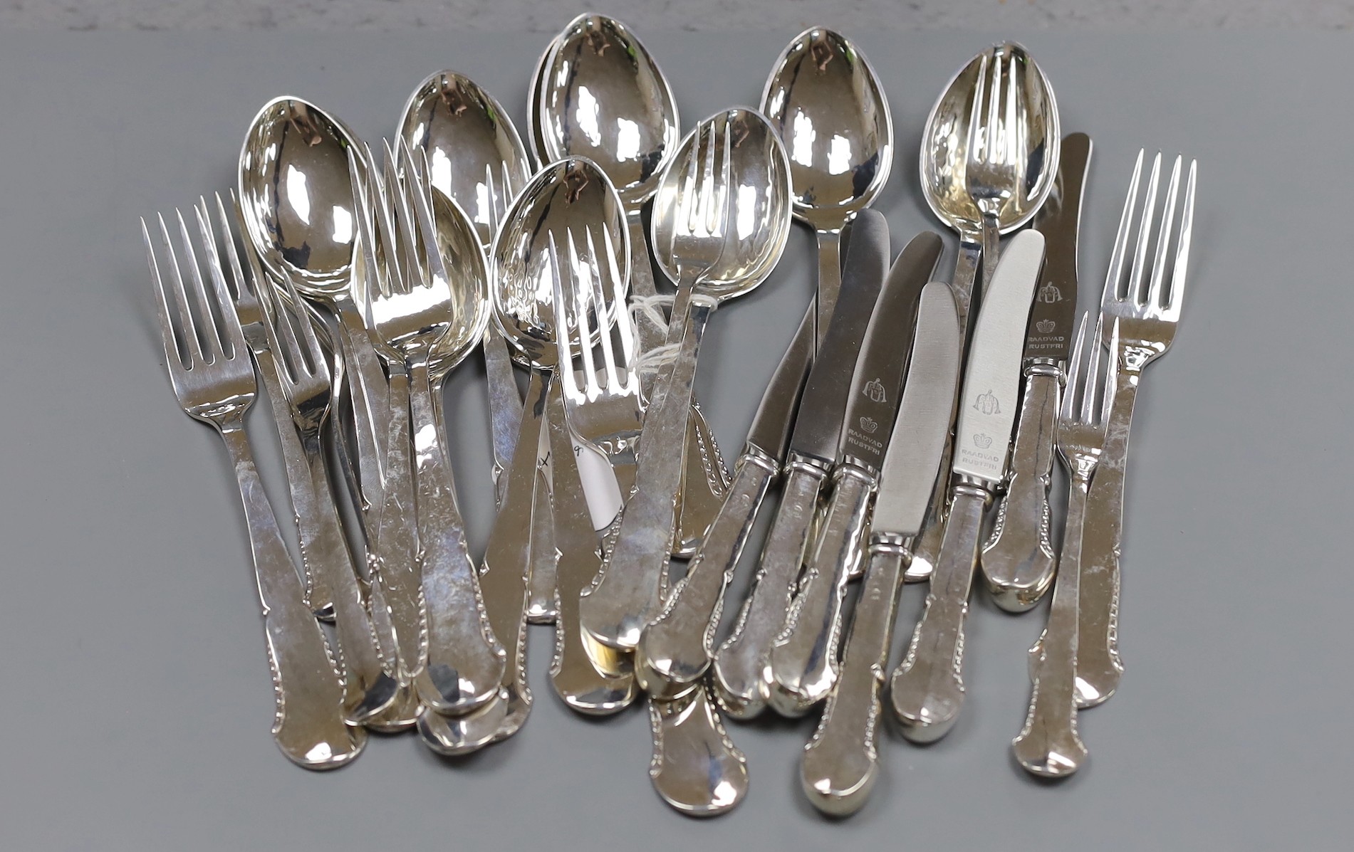 A Danish twenty eight piece white metal canteen of silver flatware and cutlery, comprising ten dessert spoons, six table forks, six three prong forks and six white metal handled steel knives